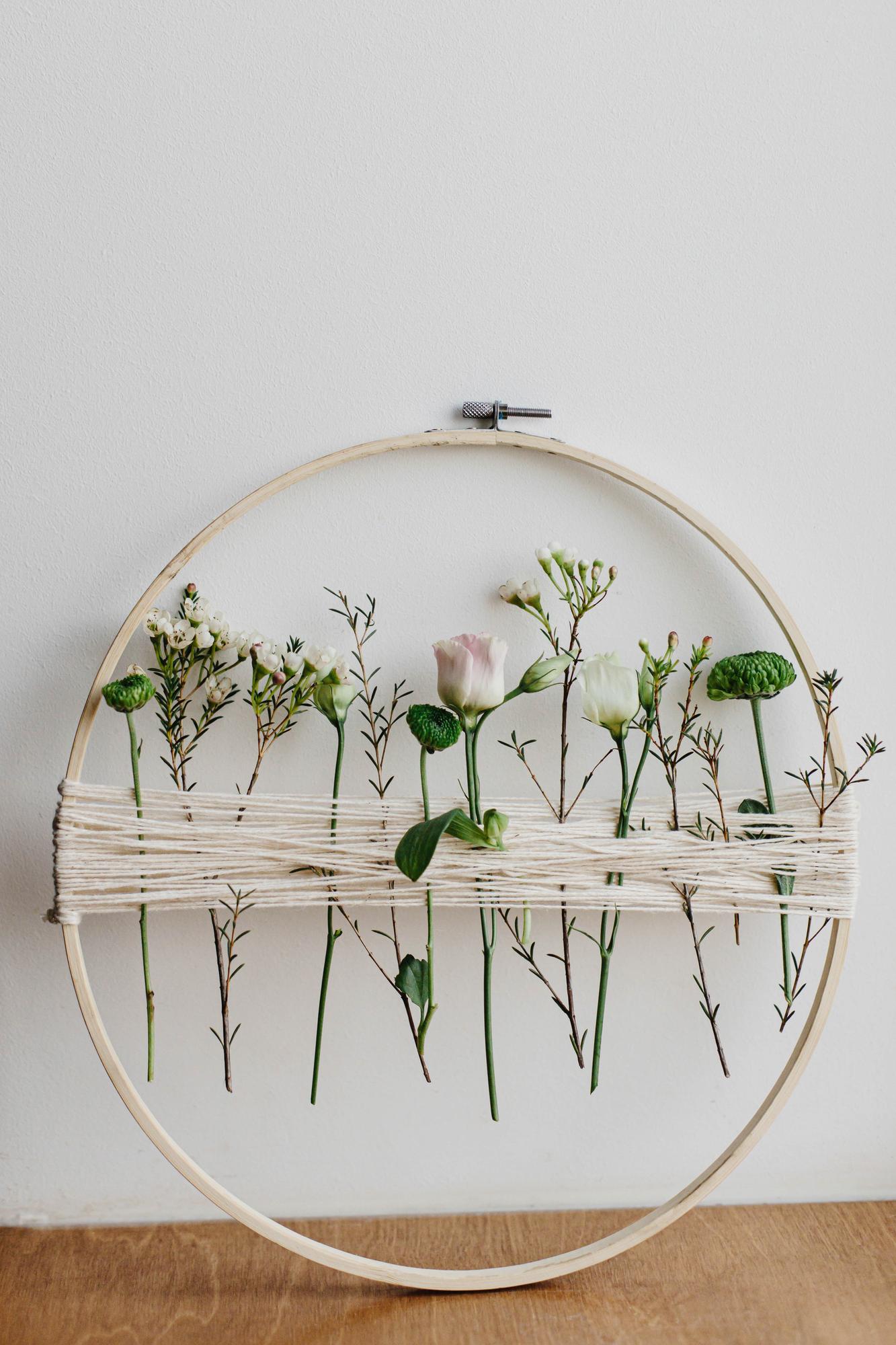 framed embroidered floral sampler on a shelf